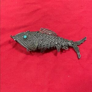 Intricate Silver Fish Necklace with Turquoise Detail.